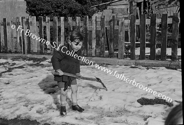 CHILD PLAYING WITH SHOVEL